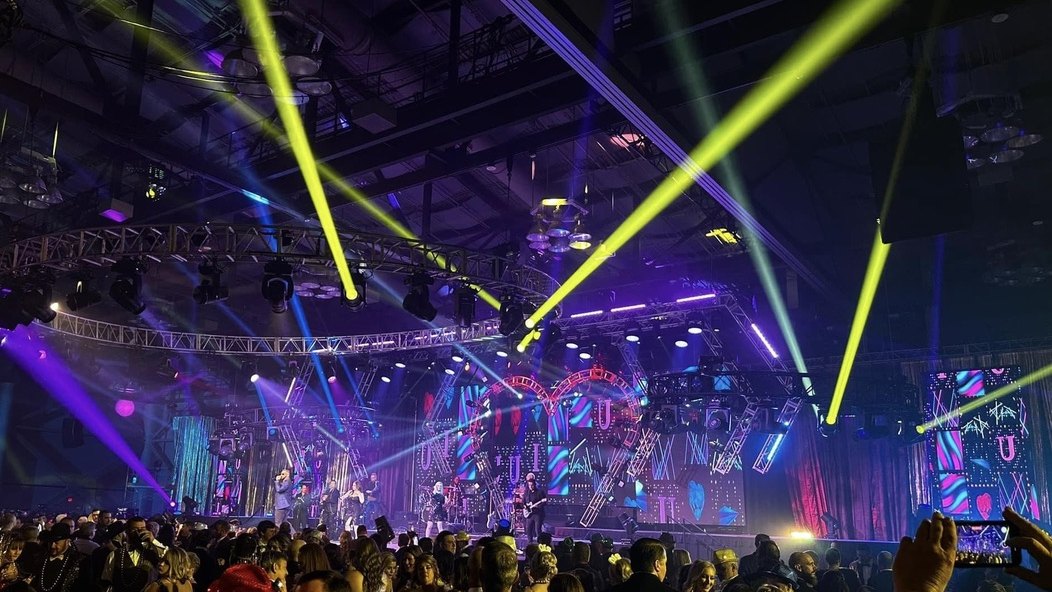 Sugar Shaker performing to a packed convention centre crowd under full beam lighting