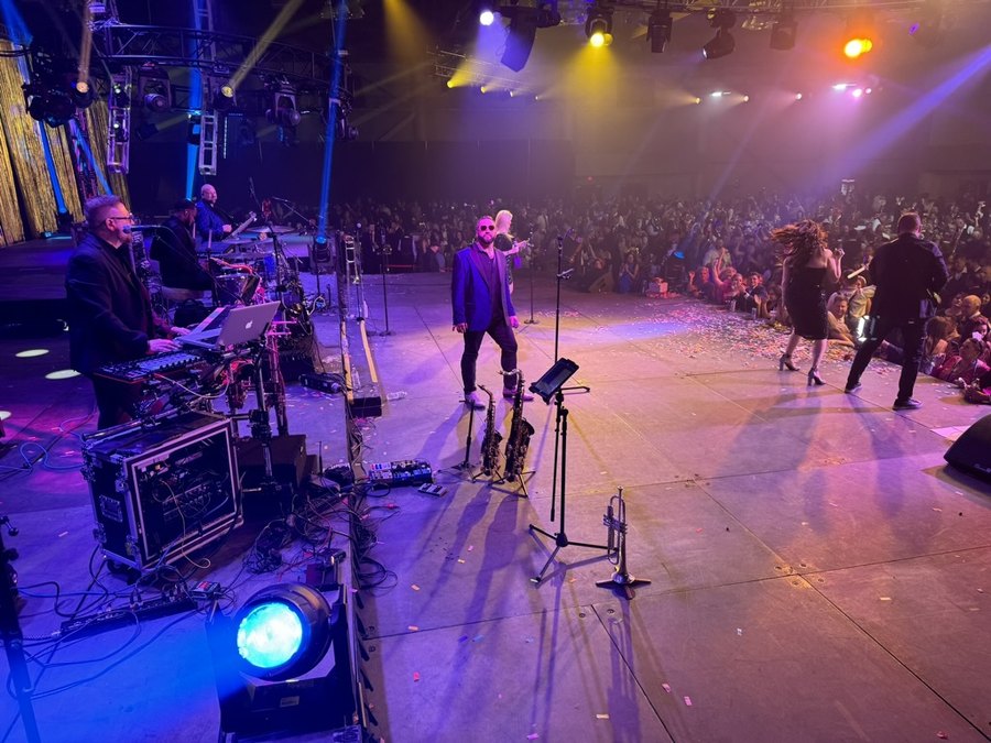 Sugar Shaker on stage with dancers and confetti at the close of a corporate event