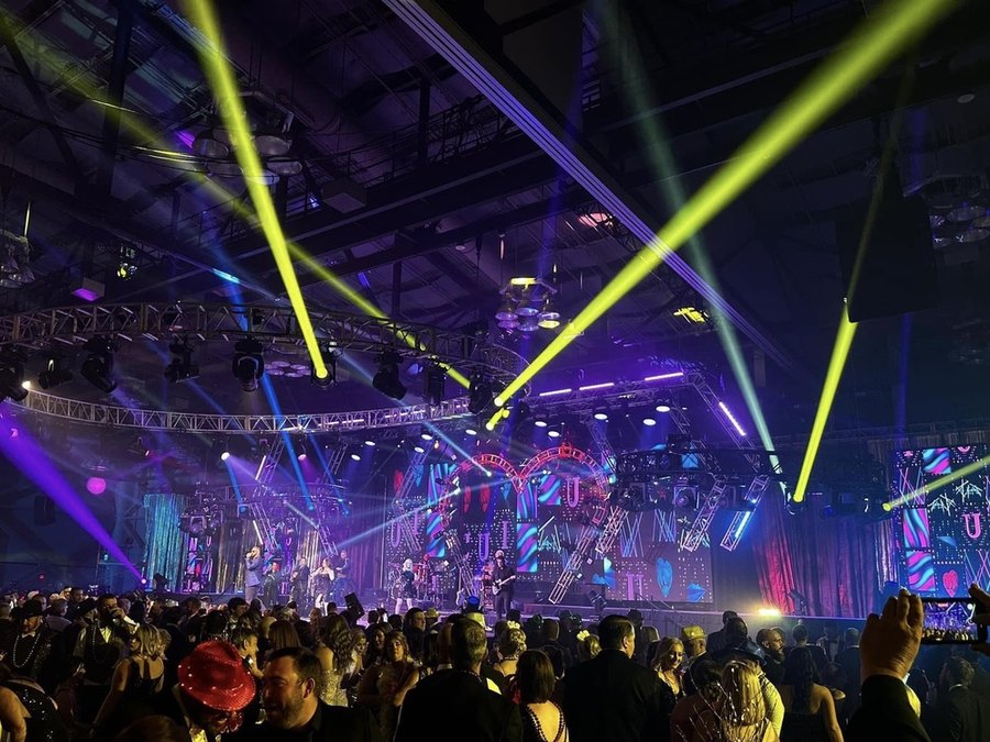 Sugar Shaker performing to a packed convention centre floor under full beam lighting