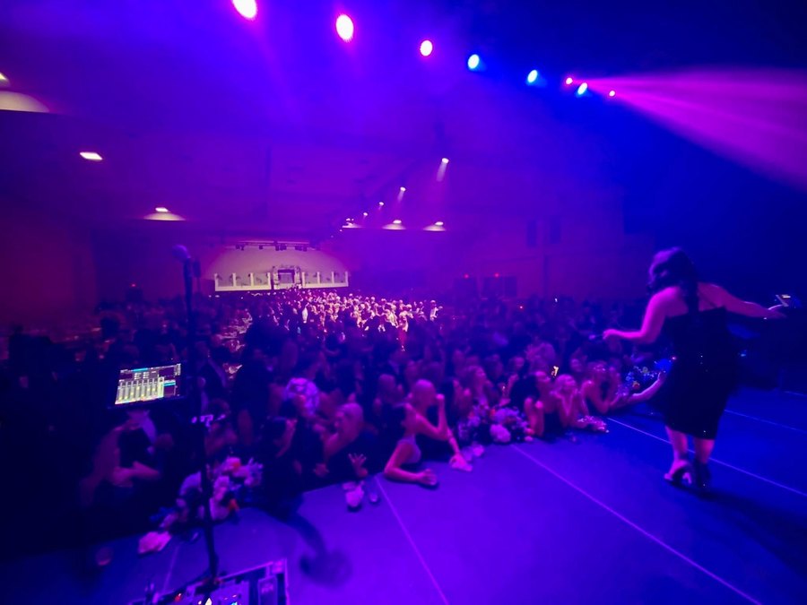 The view from the Sugar Shaker stage across a seated black-tie corporate audience