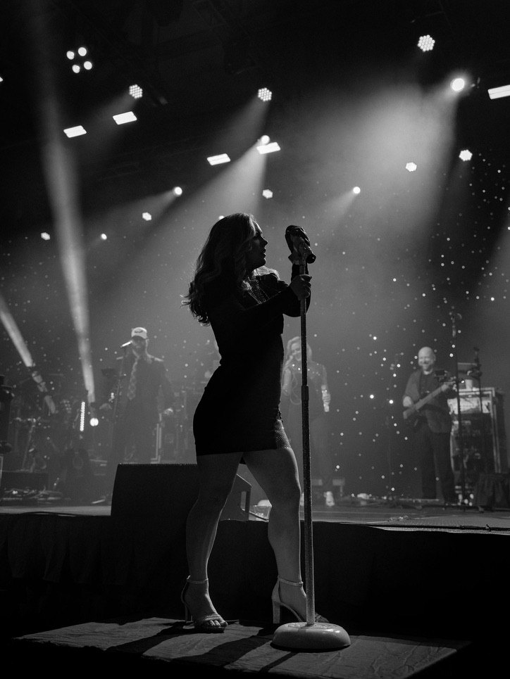 Sugar Shaker’s lead vocalist silhouetted on a corporate event stage