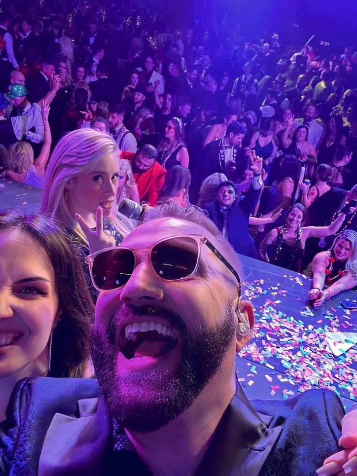 Sugar Shaker vocalists on stage with a confetti-covered crowd behind them