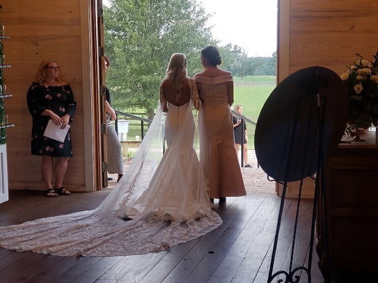 A bride heading out to her ceremony at a Louisiana wedding venue