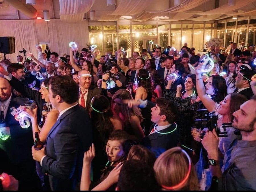 A packed wedding dance floor during a Sugar Shaker reception set